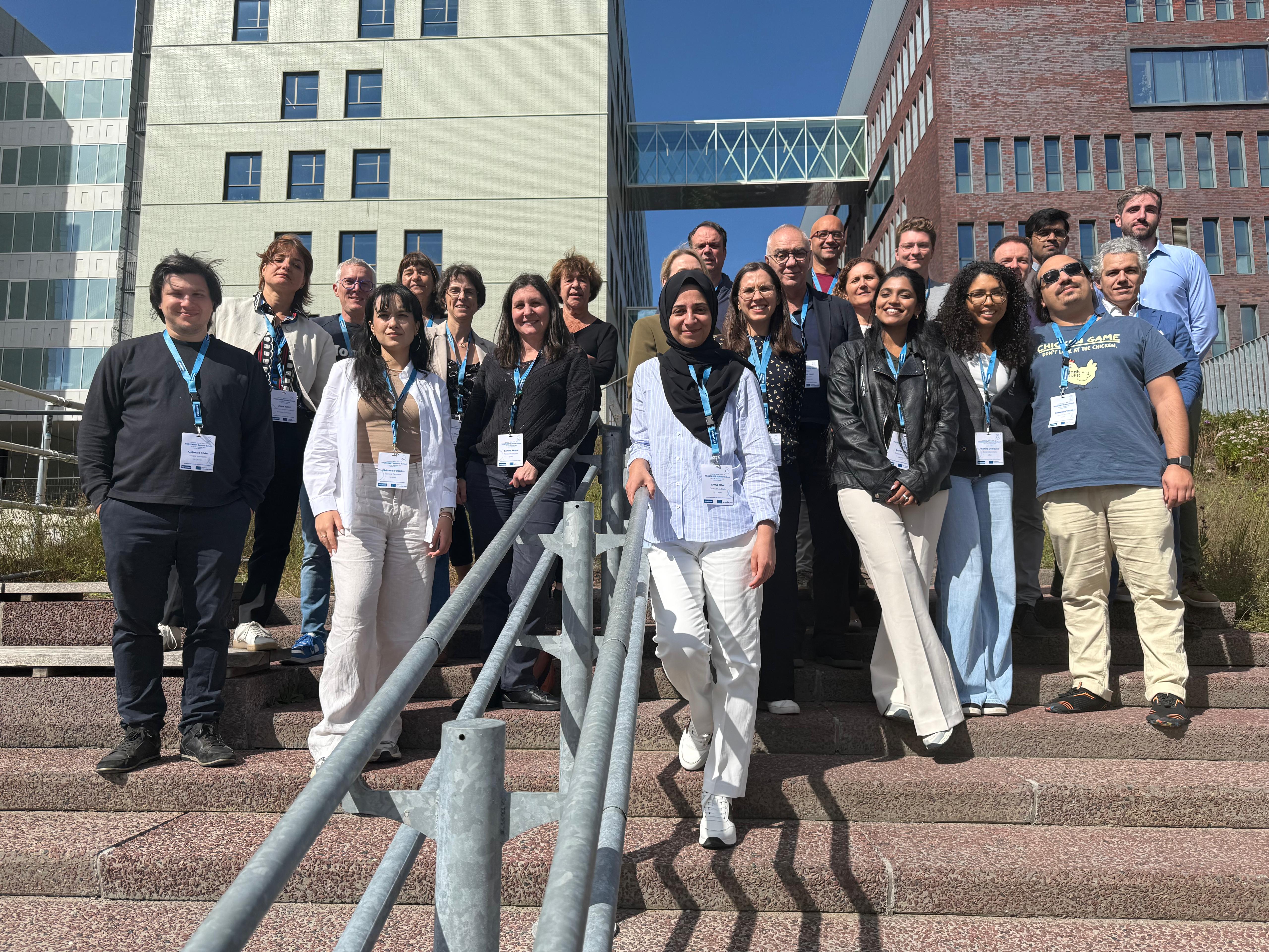 A group of researchers standing on stairs to take a group photo